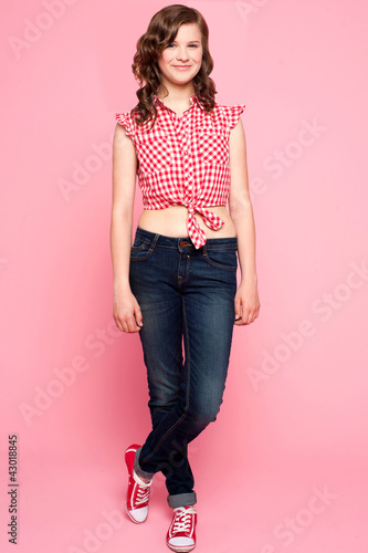 Foto: Pretty teenager standing with crossed legs Pretty teenager standing with crossed legs
