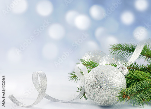Photo: Christmas branch of tree ribbon bauble and snow Christmas branch of tree ribbon bauble and snow