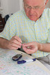 Pensioner taking blood sample
