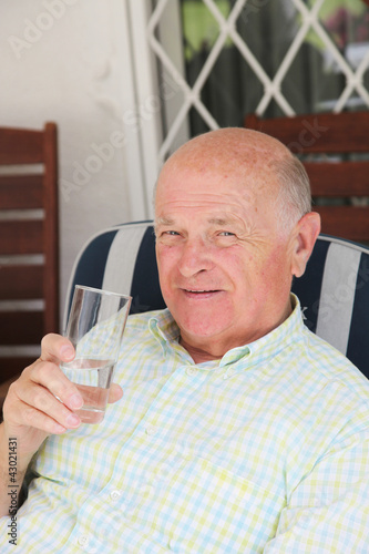 Photo: Thirsty senior man drinking water Thirsty senior man drinking water