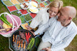 Photo: Happy Couple with BBQ in Park Happy Couple with BBQ in Park