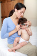 Photo: Mother taking babies temperature Mother taking babies temperature