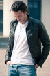 Young casual man portrait with leather jacket outdoors.