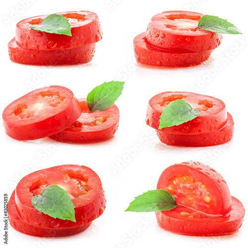 Photo: Collection of tomato slices on white and leaf of basil Collection of tomato slices on white and leaf of basil