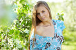 Spring woman in summer dress walking in park