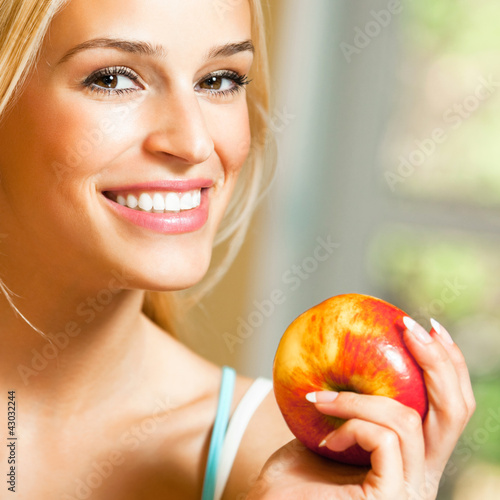 Photo: Happy smiling woman with apple Happy smiling woman with apple