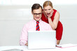 Shocked woman looking into laptop. Man working