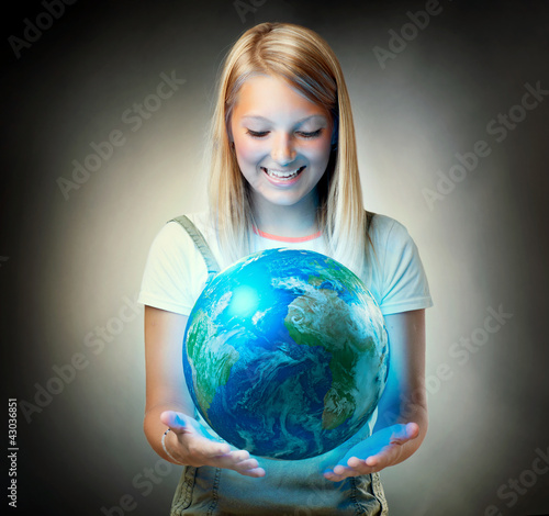 Photo: Girl holding the Planet Earth. Future Concept Girl holding the Planet Earth. Future Concept