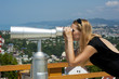 Woman on vacation looking through binoculars