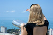 Foto: Woman on vacation looking through binoculars Woman on vacation looking through binoculars