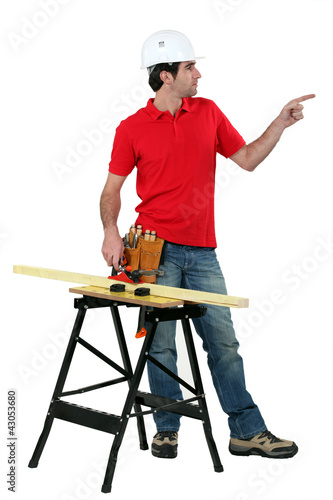 Photo: Carpenter pointing to empty copyspace Carpenter pointing to empty copyspace