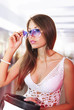 girl tries on white fashion glasses