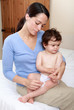 Mother applying cream to baby's rash
