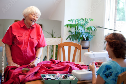 Photo: Volunteer helping senior with sewing project Volunteer helping senior with sewing project