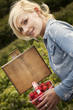 woman holding a punnet of freshly picked strawberries