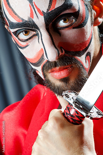 Photo: Man with face mask and sword Man with face mask and sword