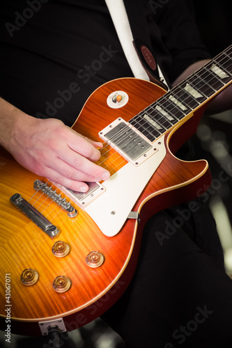 Photo: close-up of a musician playing an electric guitar close-up of a musician playing an electric guitar