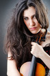 Female violin player against background
