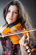 Female violin player against background