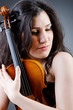 Female violin player against background