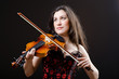 Female violin player against background
