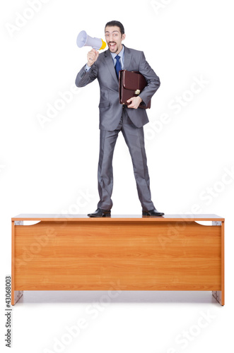 Foto: Businessman with loudspeaker at the desk Businessman with loudspeaker at the desk