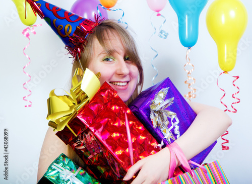 Photo: Birthday. happy young girl with gifts Birthday. happy young girl with gifts