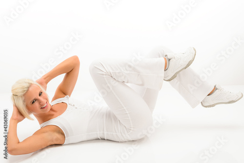 Foto: Fitness instructor exercise abdominals white floor Fitness instructor exercise abdominals white floor