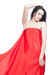 Beautiful lady in red sateen posing over white background