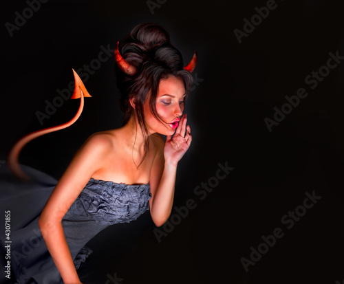 Photo: Sexy Devil woman with tail horns and red skin whispering somethi Sexy Devil woman with tail horns and red skin whispering somethi
