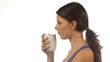 Yong woman drinking tea isolated