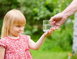 Little girl with taking  glass of water