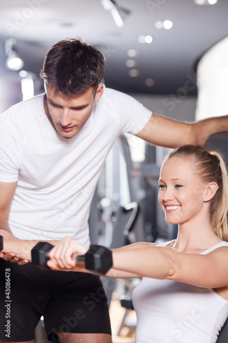 Photo: Woman exercising with personal trainer Woman exercising with personal trainer