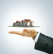 Illustration: Hotel building in businessman's hand Hotel building in businessman's hand