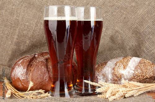 Photo: two glasses of kvass with bread on canvas background close-up two glasses of kvass with bread on canvas background close-up