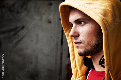 Photo: Young man portrait on graffiti grunge wall Young man portrait on graffiti grunge wall