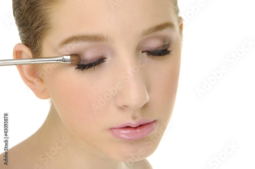 Photo: Young woman applying eye shadow Young woman applying eye shadow