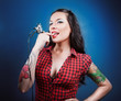 Photo of beautiful girl with tattoos and tattoo machine