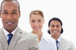 Big close-up of workmates in a single line smiling