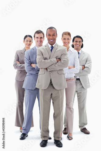 Photo: Smiling business team crossing their arms Smiling business team crossing their arms