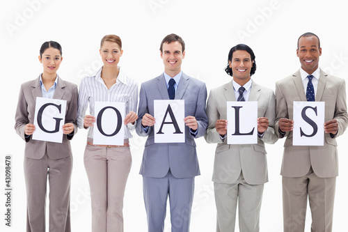 Photo: Happy business team holding the letters of GOALS Happy business team holding the letters of GOALS