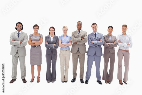 Photo: Smiling business team crossing their arms side by side Smiling business team crossing their arms side by side