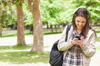 Foto: Young student using a smartphone Young student using a smartphone
