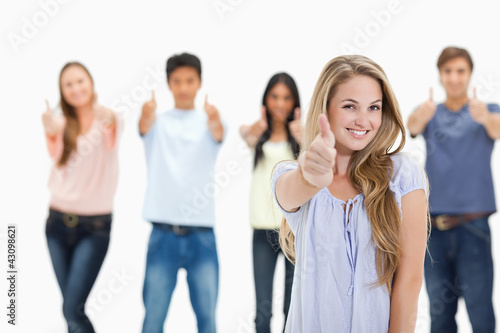 Photo: Close-up of people smiling and approving with one woman in foreg Close-up of people smiling and approving with one woman in foreg