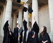 Photo: Smiling graduates throwing their hats in the sky Smiling graduates throwing their hats in the sky