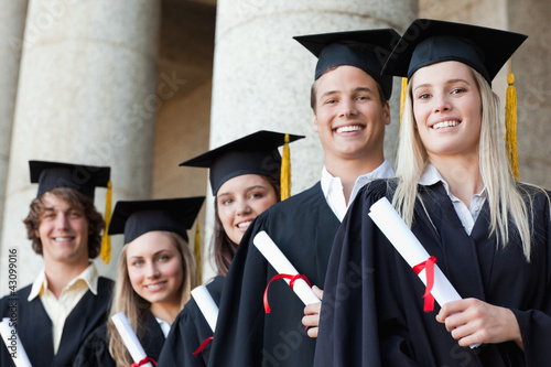Photo: Close-up of five smiling graduates posing Close-up of five smiling graduates posing