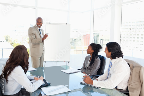 Photo: Businessman giving a presentation in front of his colleagues Businessman giving a presentation in front of his colleagues