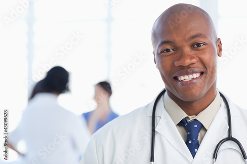 Photo: Smiling doctor standing with his stethoscope around his neck Smiling doctor standing with his stethoscope around his neck