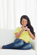 Happy Latino looking her smartphone