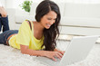 Beaming Latin woman using a laptop